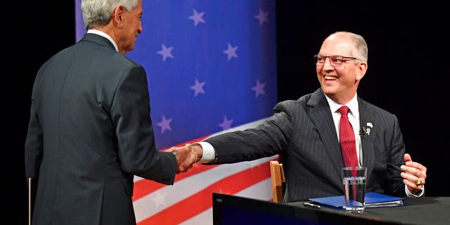 Eddie Rispone, left, and John Bel Edwards shaking hands before a debate last week in Baton Rouge. [Hilary Scheinuk/The Advocate via AP)