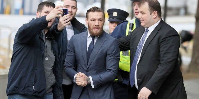 UFC fighter Conor McGregor arrives at the District Court where he pleaded guilty Friday to an assault charge after allegedly punching a man at a pub, in Dublin on Friday. (Brian Lawless/PA via AP)