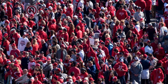 Fans wait for the start Saturday's parade. AP Photo/Cliff Owen)