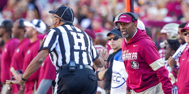 Florida State head coach Willie Taggart, right, disagrees with the referee in the first half of an NCAA college football game against Miami in Tallahassee, Fla.