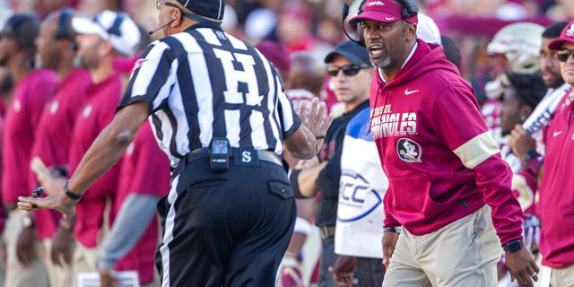 Florida State head coach Willie Taggart, right, disagrees with the referee in the first half of an NCAA college football game against Miami in Tallahassee, Fla.