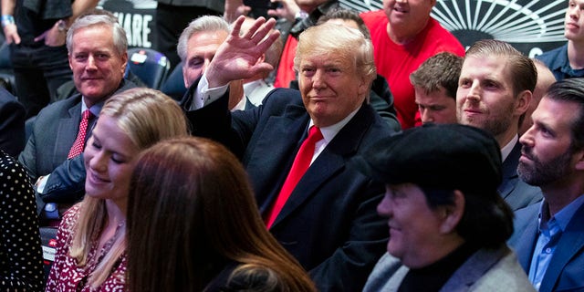 President Trump -- accompanied by (from left) Reps. Mark Meadows and Kevin McCarthy, and sons Eric and Donald Jr. -- ​waving at Madison Square Garden while attending the UFC 244 fights Saturday in New York City. (AP Photo/ Evan Vucci)