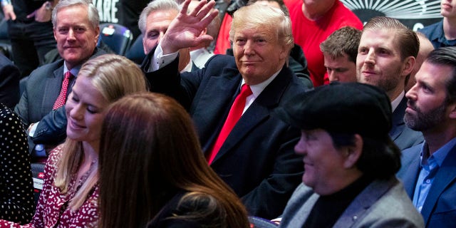 President Trump -- accompanied by (from left) Reps. Mark Meadows and Kevin McCarthy, and sons Eric and Donald Jr. -- waving at Madison Square Garden while attending the UFC 244 fights Saturday in New York City. (AP Photo/ Evan Vucci)