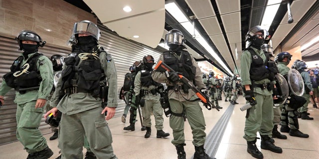 Riot police form a line at a shopping mall in Hong Kong, Sunday, Nov. 3, 2019. Riot police stormed several malls in Hong Kong on Sunday in a move to thwart more pro-democracy protests, as the city's leader heads to Beijing for talks on deepening economic integration between the semi-autonomous Chinese territory and mainland China. (AP Photo/Dita Alangkara)