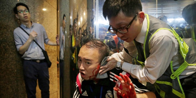 District councilor Andrew Chiu receives medical treatment in Hong Kong, on Sunday, Nov. 3, 2019. Riot police stormed several malls in Hong Kong on Sunday in a move to thwart more pro-democracy protests, though violence did break out when a knife-wielding man slashed several people and bit off part of the ear of a local pro-democracy politician. (Elson Li/HK01 via AP)