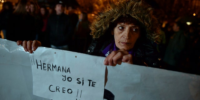 A woman holds a sign reading ''Sister. I believe you'' as people gather at Plaza del Castillo square to a protest against sex assault, in Pamplona, northern Spain, Monday, Nov. 4, 2019. (AP Photo/Alvaro Barrientos)