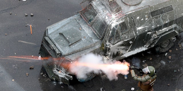 Police fire tear gas at protesters during an anti-government protest in Santiago, Chile, Monday, Nov. 4, 2019. 