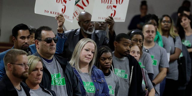 People wearing "Save The Paseo" shirts stand among attendees at a rally to keep a street named in honor of Dr. Martin Luther King Jr. at the Paseo Baptist Church in Kansas City, Mo., Nov. 3, 2019. (Associated Press)