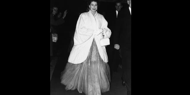 In this Nov. 28, 1952 file photo, Queen Elizabeth II, wearing an ermine coat over her full-skirted evening dress, arrives at Royal Festival Hall in London for a concert. (AP Photo, File)