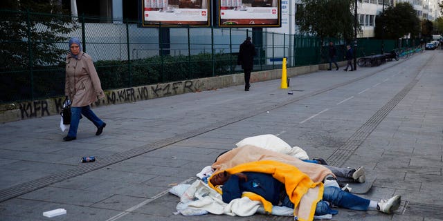 Homeless migrants sleep in the street in Paris, France, Wednesday, Nov. 6.