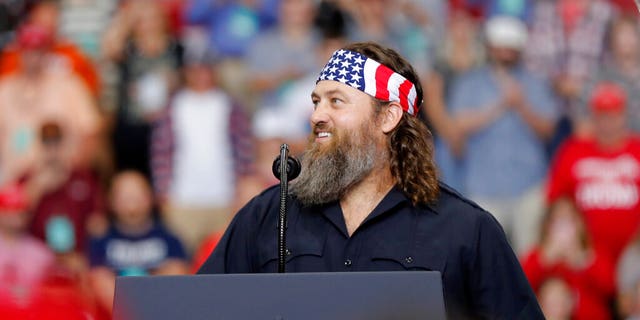 Willie Robertson, left, of the reality TV series Duck Dynasty, addressing the crowd the campaign rally for President Trump in Monroe, La., on Wednesday. [AP Photo/Gerald Herbert)