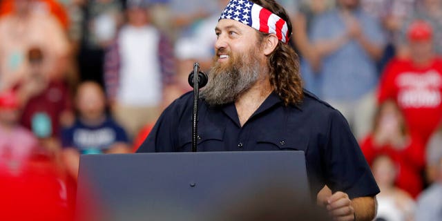 Willie Robertson, left, of the reality TV series 'Duck Dynasty,' addresses the crowd at a campaign rally for President Trump in Monroe, La., Wednesday, Nov. 6, 2019.