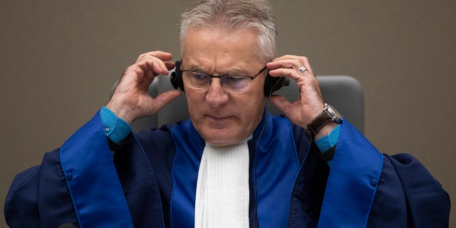 Presiding ICC judge Robert Fremr prepares to read the sentence for Congolese militia commander Bosco Ntaganda in the courtroom of the International Criminal Court in The Hague, Netherlands, Thursday, Nov. 7, 2019. (AP Photo/Peter Dejong, Pool)