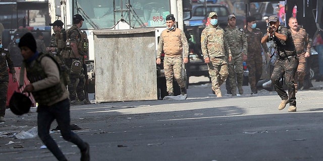 Iraqi security forces try to disperse anti-government protesters during ongoing protests in Baghdad, Iraq this week. (AP Photo/Hadi Mizban)