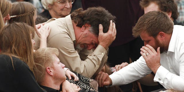 David Langford being consoled during the funeral service for his wife and sons in La Mora, Mexico, on Thursday.