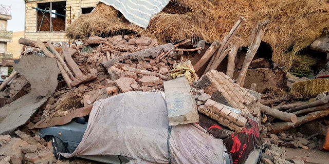 A car lays smashed by debris from an earthquake in Varankesh village in Eastern Azerbaijan province, some 250 miles (400 kilometers) northwest of the capital Tehran, Iran, Friday, Nov. 8, 2019. The temblor struck Tark county in Iran's Eastern Azerbaijan province early Friday. (Mohammad Zinali/Tasnim News Agency via AP)