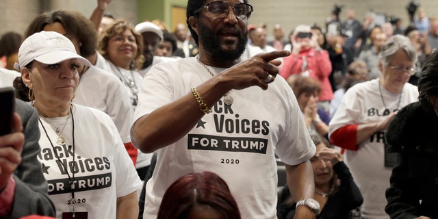 Supporters of President Donald Trump wait to listen to him speak during the launch of