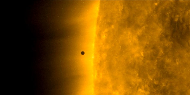 This still image from video issued by NASA's Solar Dynamics Observatory shows Mercury as it passes between Earth and the sun on Monday. The solar system's smallest, innermost planet resembles a tiny black dot during the transit, which began at 7:35 a.m. EST (1205 UTC). (NASA Solar Dynamics Observatory via AP)