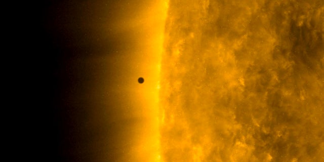 This still image from video issued by NASA's Solar Dynamics Observatory shows Mercury as it passes between Earth and the sun on Monday. The solar system's smallest, innermost planet resembles a tiny black dot during the transit, which began at 7:35 a.m. EST (1205 UTC). (NASA Solar Dynamics Observatory via AP)