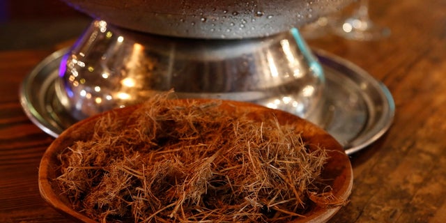 A sample of elephant dung is shown at a gin tasting session at the Botlierskop Private Game Reserve, near Mossel Bay, South Africa, Monday, Oct. 23. (AP Photo/Denis Farrell)