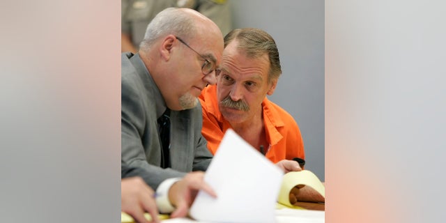 In 2005, Ron Lafferty, right, confers with his attorney. (AP Photo/George Frey, File)