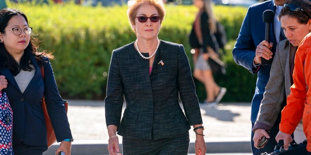 ​​​​​​​Former U.S. ambassador to Ukraine Marie Yovanovitch, center, arrives on Capitol Hill, Friday, Oct. 11, 2019, in Washington, to testify before congressional lawmakers as part of the House impeachment inquiry into President Donald Trump. (Associated Press)