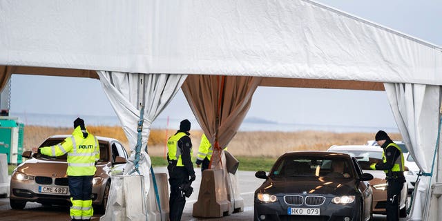 Danish police inspect passengers from Sweden near a motorway exiting a tunnel near Copenhagen, Denmark.