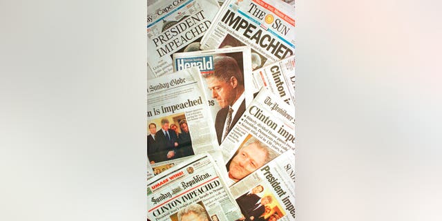 The Dec. 20, 1998 editions of newspapers from Massachusetts and Rhode Island with headlines of President Clinton's impeachment. (AP Photo/Peter Lennihan, File)