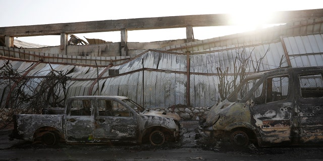 Burnt cars sit after a Tuesday's rocket firing from Gaza, in Sderot, southern Israel, Wednesday, Nov. 13, 2019. Gaza officials say new Israel airstrikes have killed a few militants. (AP Photo/Ariel Schalit)