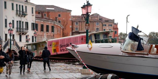 Boats are stranded on the docks after a high tide, in Venice. (Andrea Merola/ANSA via AP)