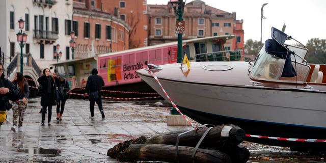 Boats are stranded on the docks after a high tide, in Venice. (Andrea Merola/ANSA via AP)