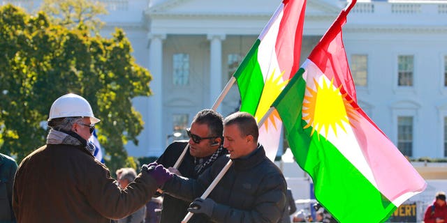 Demonstrators hold Kurdistan flags in front of the White House as thy protest Erdogan's visit Wednesday. (AP Photo/Steve Helber)