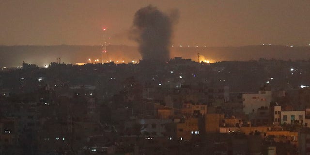 An explosion caused by Israeli airstrikes is seen in Gaza City, early Thursday, Nov. 14, 2019. (AP Photo/Adel Hana)
