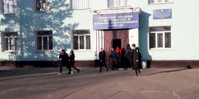In this photo provided by Vera Zaderko, students leave a college after a shooting in Blagoveshchensk, Russia, Thursday, Nov. 14, 2019. (Associated Press)