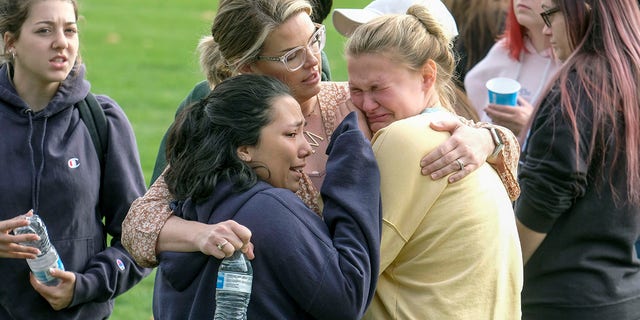 Students are comforted as they wait to be reunited with their parents following a shooting at Saugus High School that injured several people on Thursday in Santa Clarita, Calif. (AP Photo/Ringo H.W. Chiu)