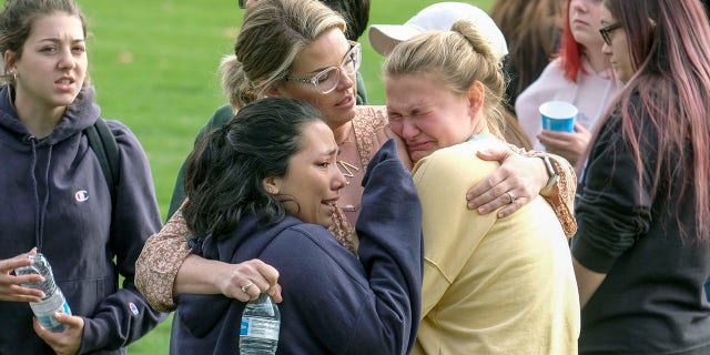 Students are comforted as they wait to be reunited with their parents following a shooting at Saugus High School that injured several people, Thursday, Nov. 14, 2019, in Santa Clarita, Calif.