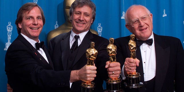 From left: Douglas Wick, David Franzoni and Branko Lustig hold their Oscars backstage at the Shrine Auditorium in Los Angeles, after "Gladiator" was honored as best picture of the year by the Academy of Motion Pictures Arts & Sciences.