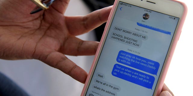 Bernadette Song Cuan shows text messages she received from her son Karl while he was on lockdown during a school shooting at Saugus High School on Thursday, Nov. 14, 2019 in Santa Clarita, Calif. (Associated Press)