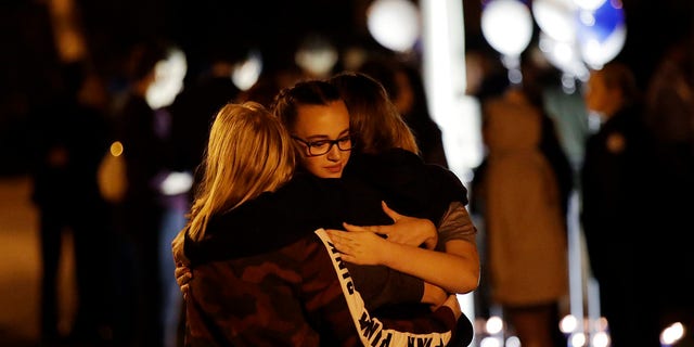 Students embrace during a vigil at Central Park in the aftermath of a shooting at Saugus High School Thursday, Nov. 14, 2019, in Santa Clarita, Calif. Los Angeles County sheriff’s officials say a 16-year-old student shot five classmates and then himself in a quad area of Saugus High School Thursday morning. (AP Photo/Marcio Jose Sanchez)