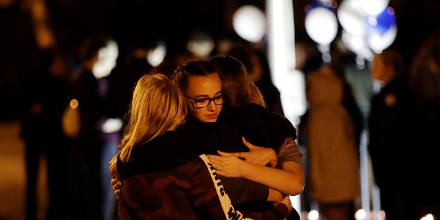 Students embrace during a vigil at Central Park in the aftermath of a shooting at Saugus High School Thursday, Nov. 14, 2019, in Santa Clarita, Calif. Los Angeles County sheriff’s officials say a 16-year-old student shot five classmates and then himself in a quad area of Saugus High School Thursday morning. (AP Photo/Marcio Jose Sanchez)