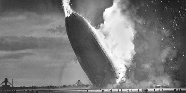 In this May 6, 1937 file photo, the German dirigible Hindenburg crashes to earth in flames after exploding at the U.S. Naval Station in Lakehurst, N.J. Werner Gustav Doehner, the last survivor of the disaster, died Nov. 8, 2019 at age 90 in Laconia, N.H. Doehner was 8 years old when he boarded the zeppelin in Germany with his parents and older siblings to return from a vacation. (AP Photo/Murray Becker, File)