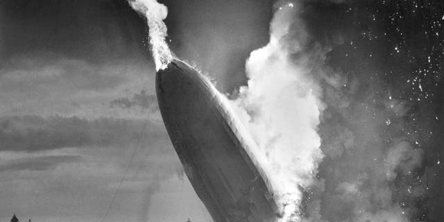 In this May 6, 1937 file photo, the German dirigible Hindenburg crashes to earth in flames after exploding at the U.S. Naval Station in Lakehurst, N.J. Werner Gustav Doehner, the last survivor of the disaster, died Nov. 8, 2019 at age 90 in Laconia, N.H. Doehner was 8 years old when he boarded the zeppelin in Germany with his parents and older siblings to return from a vacation. (AP Photo/Murray Becker, File)