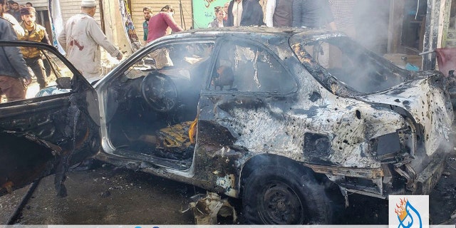 This photo provided by the Syrian anti-government activist group Albab City, which has been authenticated based on its contents and other AP reporting, people check the aftermath of a car bomb exploded in the city of al-Bab, northern Syria, Saturday, Nov. 16, 2019. A car bomb exploded Saturday in a northern Syrian town controlled by Turkey-backed opposition fighters, killing at least 18 people and wounding several others, Syrian opposition activists and Turkey's Defense Ministry said. (Albab City via AP)