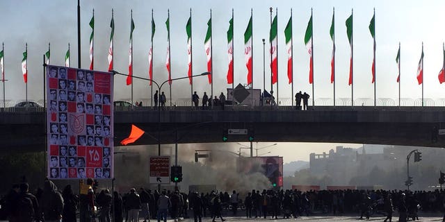 Smoke rises during a protest in the city of Isfahan Saturday. (AP Photo)