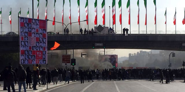 Smoke rises during a protest after authorities raised gasoline prices, in the central city of Isfahan, Iran, Saturday, Nov. 16, 2019. Demonstrators angered by a 50% increase in government-set gasoline prices blocked traffic in major cities and occasionally clashed with police Saturday after a night of demonstrations punctuated by gunfire.