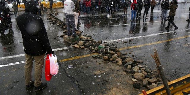 A road is blocked by protesters in Tehran Saturday. (Majid Khahi/ISNA via AP)