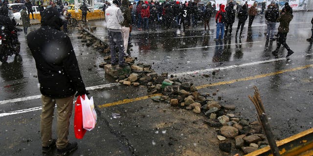 A road is blocked by protestors after authorities raised gasoline prices, in Tehran, Iran, Saturday, Nov. 16, 2019. Protesters angered by Iran raising government-set gasoline prices by 50% blocked traffic in major cities and occasionally clashed with police Saturday after a night of demonstrations punctuated by gunfire.