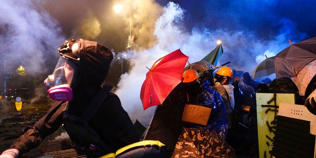 Protestors reacting as police fired tear gas near Hong Kong Polytechnic University after police gave protestors an ultimatum to leave the campus in Hong Kong.