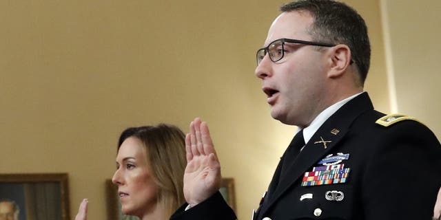 Jennifer Williams, an aide to Vice President Mike Pence, and National Security Council aide Lt. Col. Alexander Vindman, are sworn in before they testify before the House Intelligence Committee on Capitol Hill in Washington, Tuesday, Nov. 19, 2019, during a public impeachment hearing of President Donald Trump's efforts to tie U.S. aid for Ukraine to investigations of his political opponents. (AP Photo/Alex Brandon)