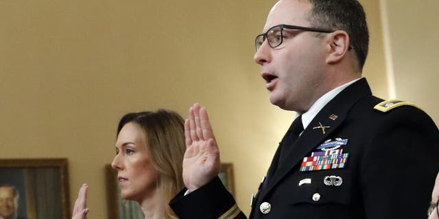 Jennifer Williams, an aide to Vice President Mike Pence, and National Security Council aide Lt. Col. Alexander Vindman, are sworn in before they testify before the House Intelligence Committee on Capitol Hill in Washington, Tuesday, Nov. 19, 2019, during a public impeachment hearing of President Donald Trump's efforts to tie U.S. aid for Ukraine to investigations of his political opponents. (AP Photo/Alex Brandon)